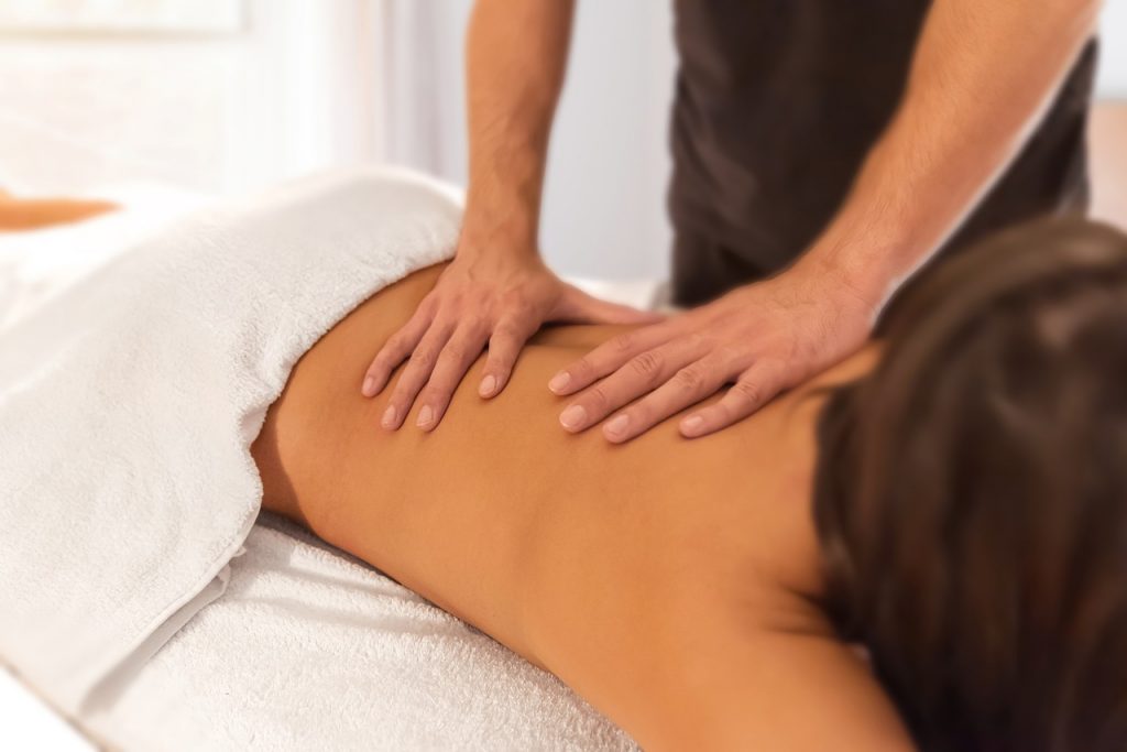 Massage therapist in Poole, applying deep tissue techniques to relieve muscle tension and stress